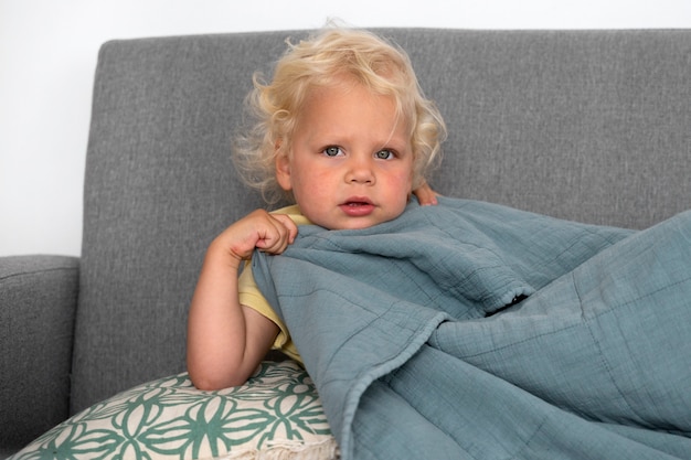 Medium Shot Boy Covering With Blanket