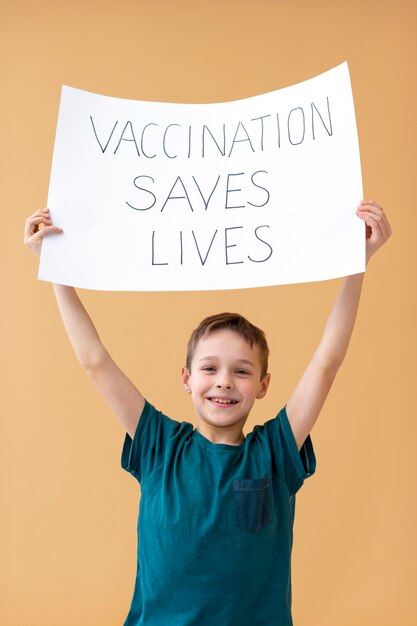 Medium shot boy holding up placard