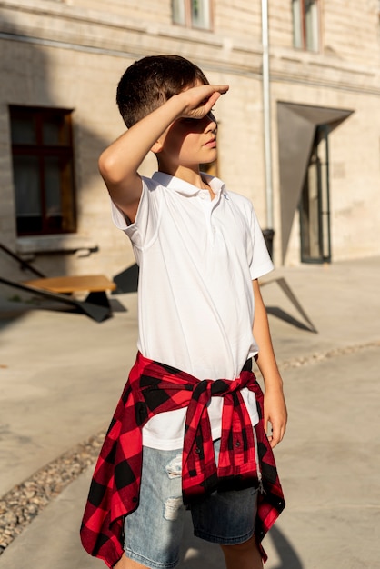 Medium shot of boy looking away