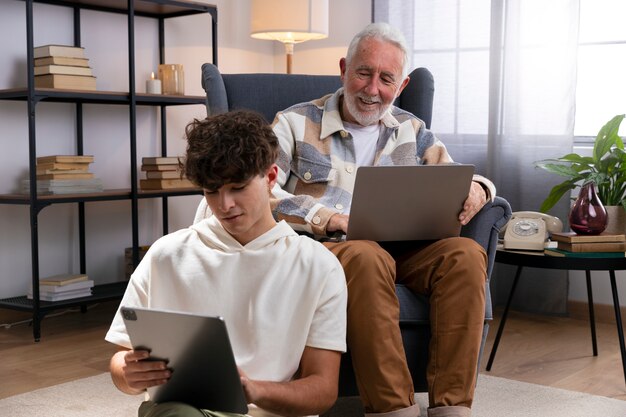 Medium shot boy and man with devices