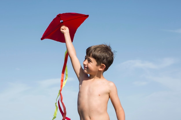 Medium shot boy playing with kite