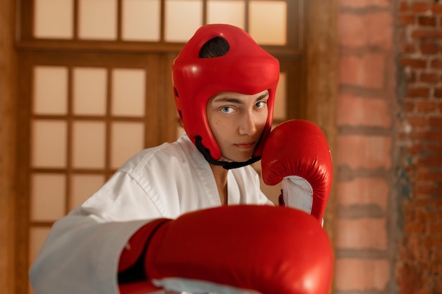 Medium shot boy practicing taekwondo