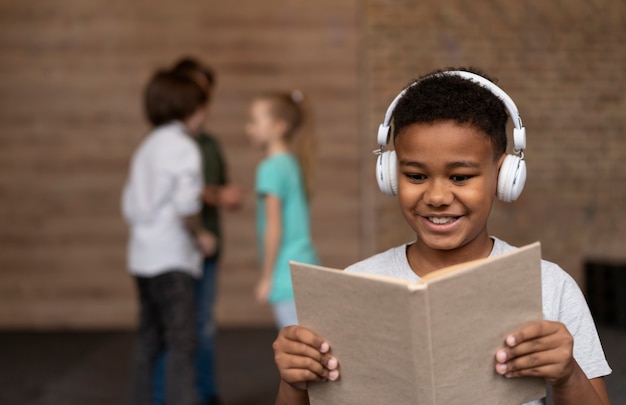 Medium shot boy reading book