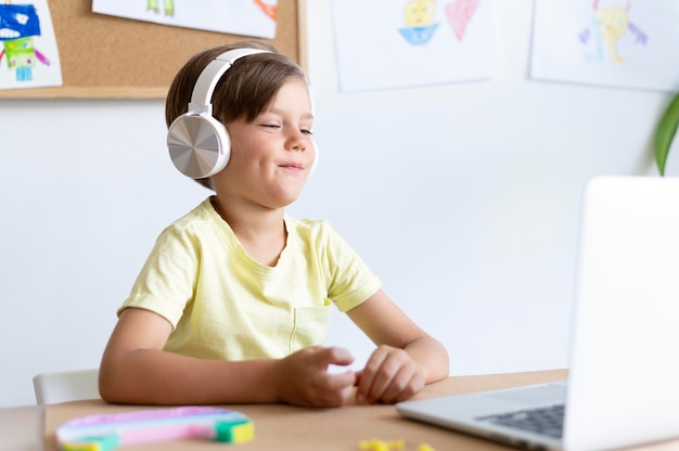 Medium shot boy wearing headphones