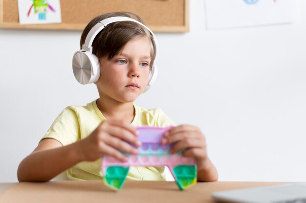 Medium shot boy wearing headphones