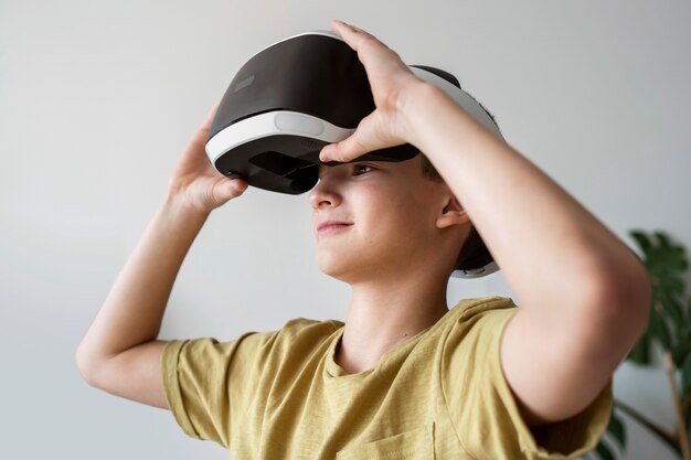 Medium shot boy wearing vr glasses