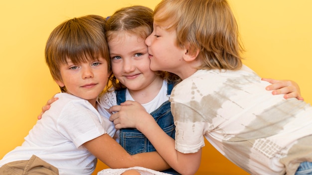 Free photo medium shot boys hugging girl