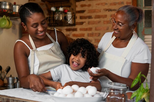 Free photo medium shot brazilian family cooking tasty desserts