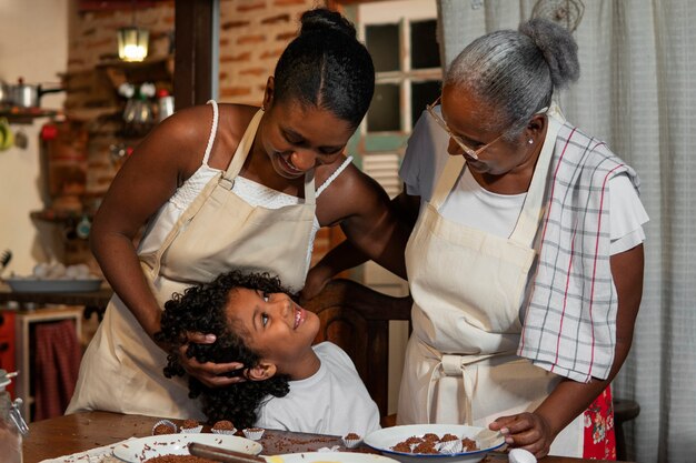 Medium shot brazilian family cooking tasty desserts