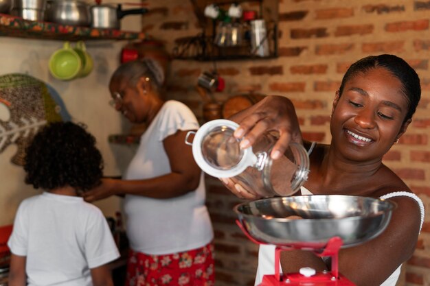 Medium shot brazilian family cooking tasty desserts