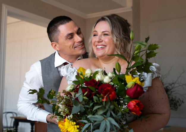 Free photo medium shot bride and groom posing together