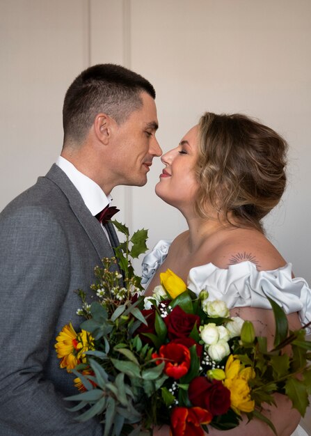 Free photo medium shot bride and groom posing together