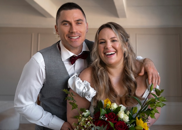 Medium shot bride and groom posing together