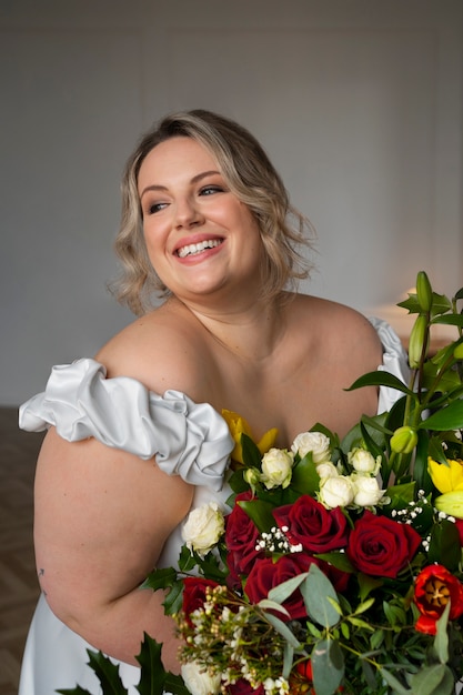 Medium shot bride posing with flowers