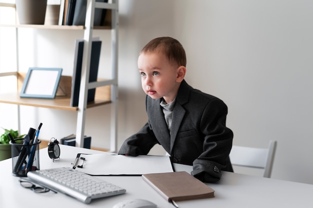 Free photo medium shot business baby at desk