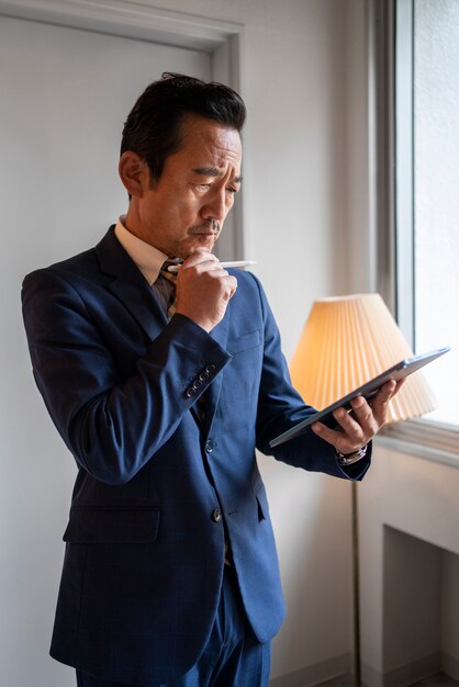 medium shot business man holding tablet