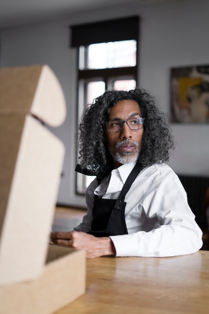 Medium shot business owner sitting at table