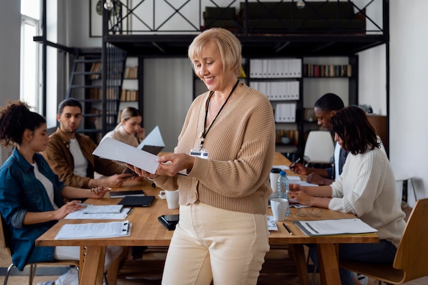 Free photo medium shot business people in conference room