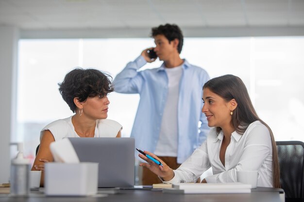 Medium shot business people with laptop