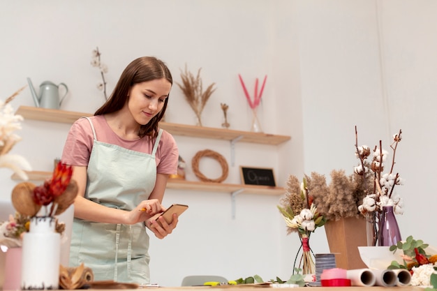 Medium shot of business woman using her mobile phone