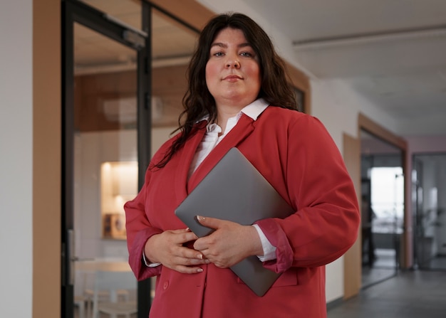 Medium shot business woman with laptop