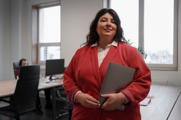 Medium shot business woman with laptop