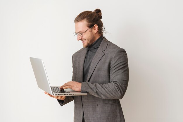 Medium shot businessman holding laptop