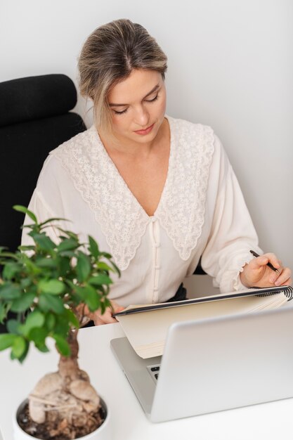 Medium shot businesswoman at desk