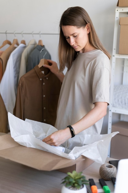 Medium shot businesswoman holding hanger