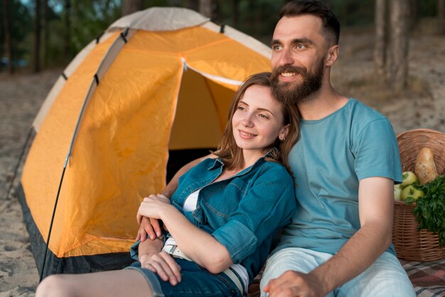 Medium shot camping couple looking away