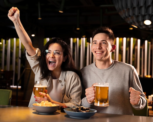 Medium shot cheerful friends in pub