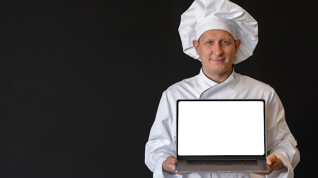 Medium shot chef holding laptop