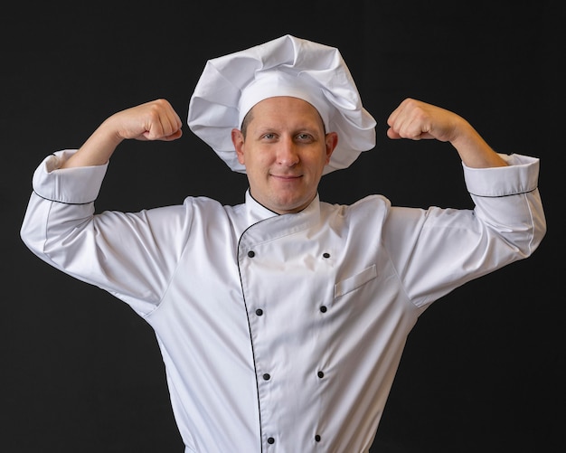 Free photo medium shot chef showing muscles