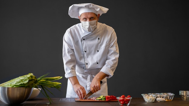 Medium shot chef wearing mask