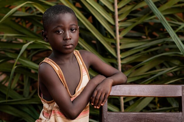 Medium shot child posing with chair