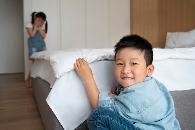 Free photo medium shot children playing hide and seek