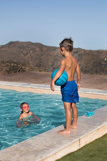 Medium shot children at swimming pool