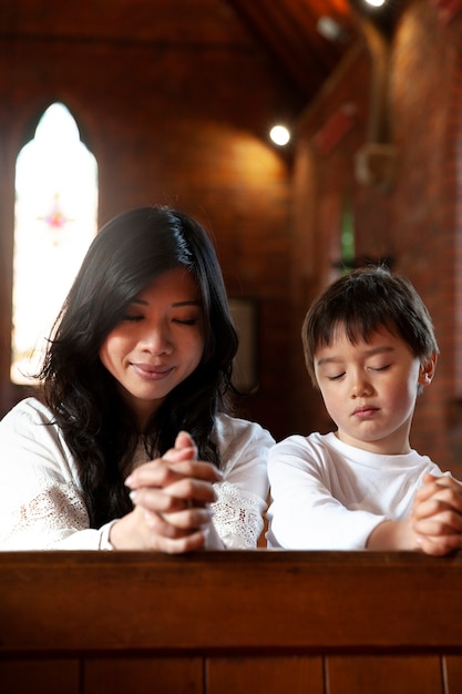 Medium shot christian family praying