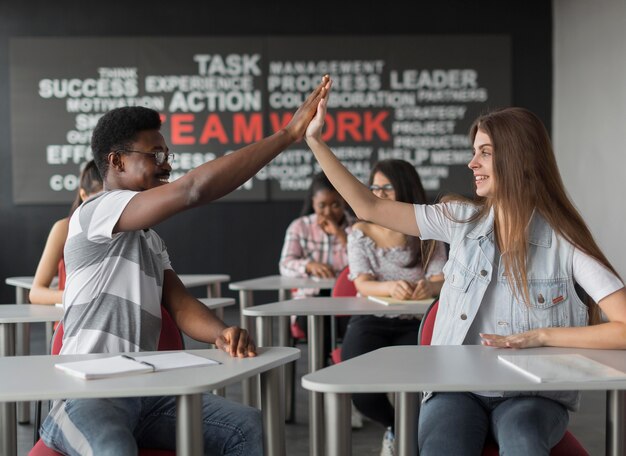 Medium shot colleagues high five