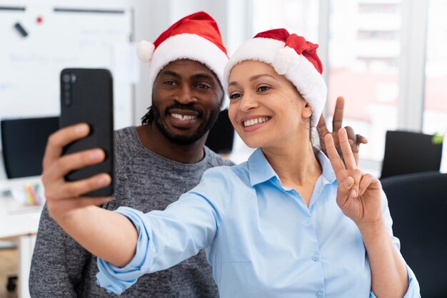 Medium shot colleagues taking selfie