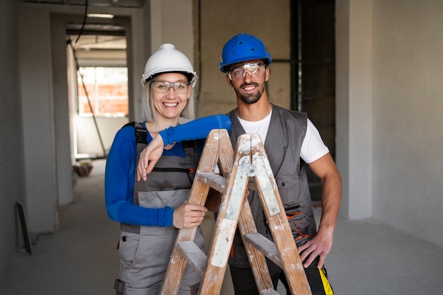 Medium shot construction workers with helmets