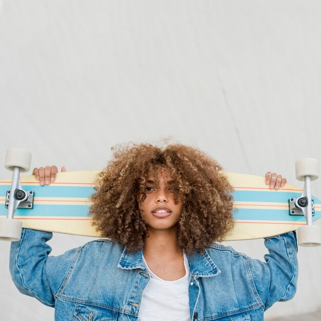 Medium shot cool girl with skateboard