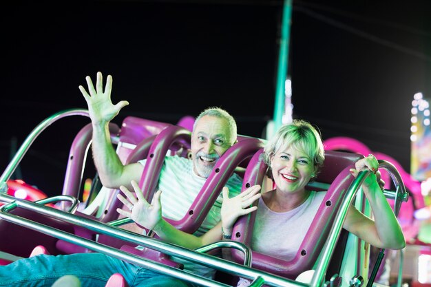 Medium shot couple in amusement ride 