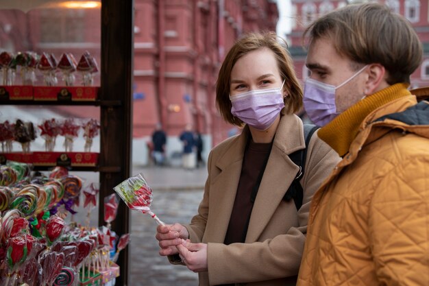 Medium shot couple buying candy