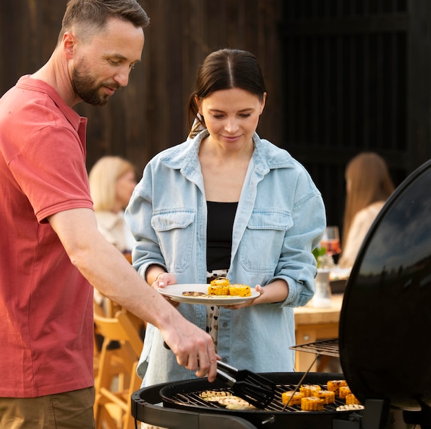 Medium shot couple cooking together