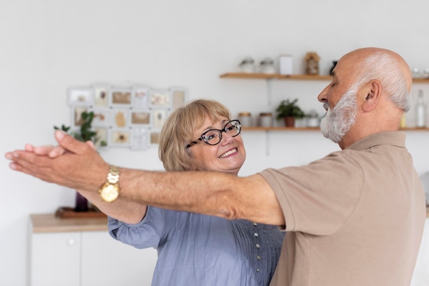 Medium shot couple dancing indoors