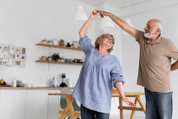 Medium shot couple dancing together