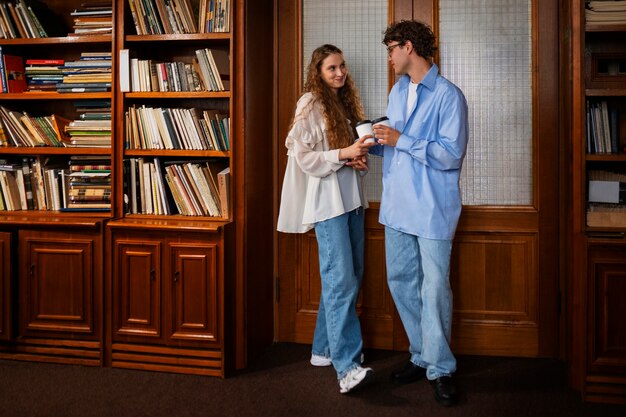 Medium shot couple having a bookstore date