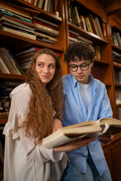 Medium shot couple having a bookstore date