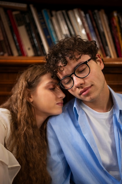 Medium shot couple having a bookstore date